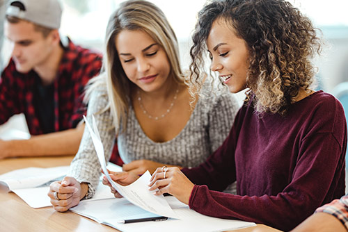 Two female students working on a project together